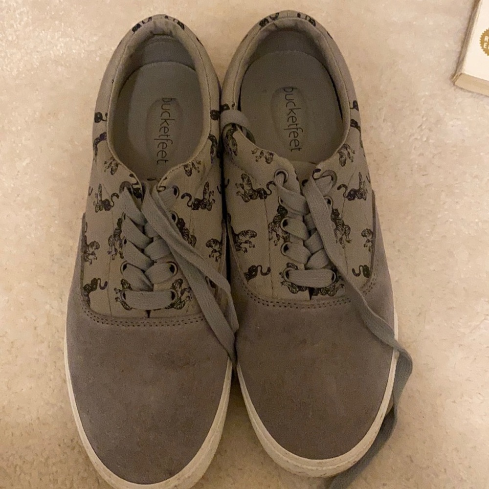 Grey suede sneakers with tigers print on them